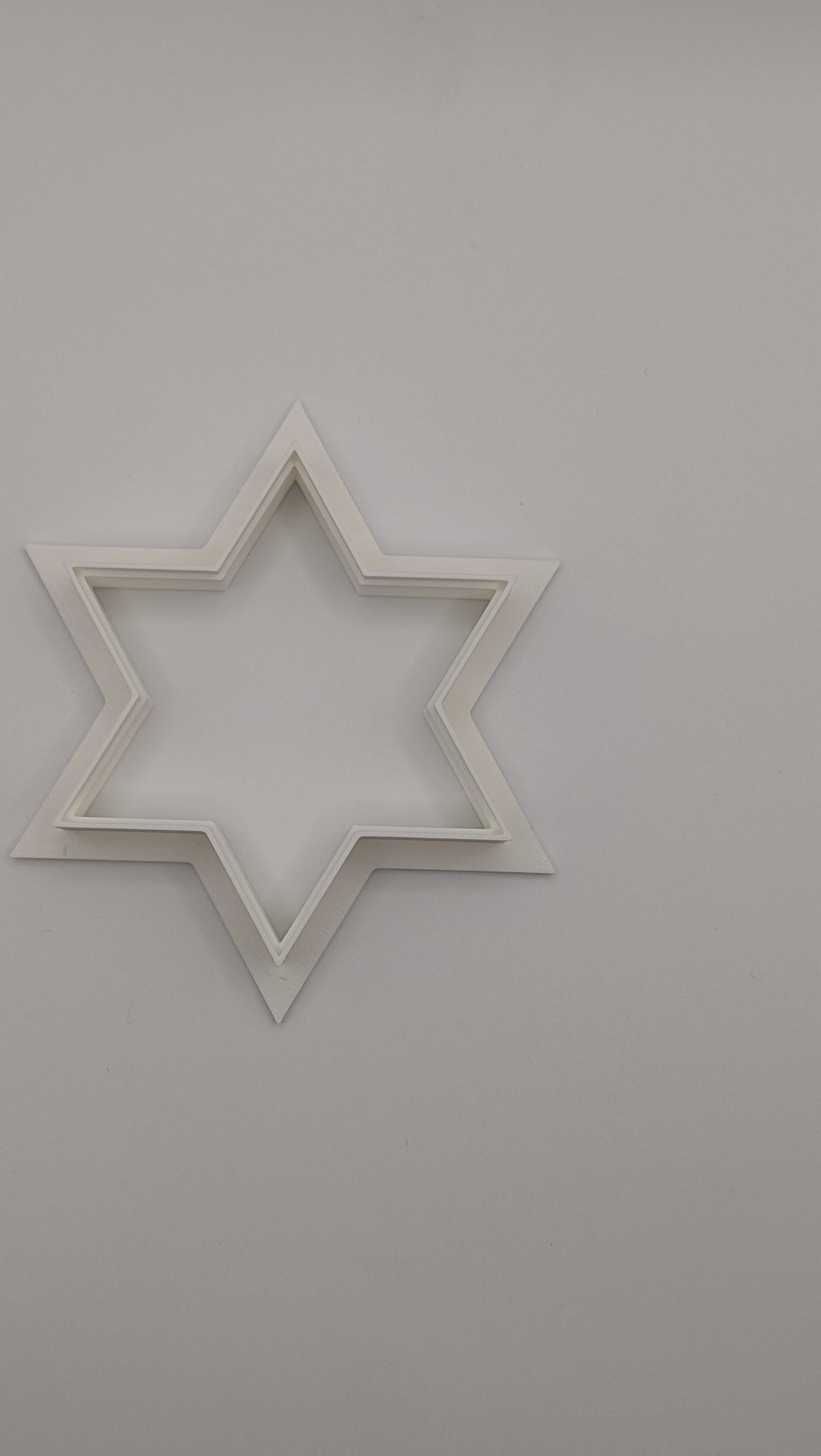 Three Star of David cookie cutters in bite, standard, and large sizes for Jewish holiday baking