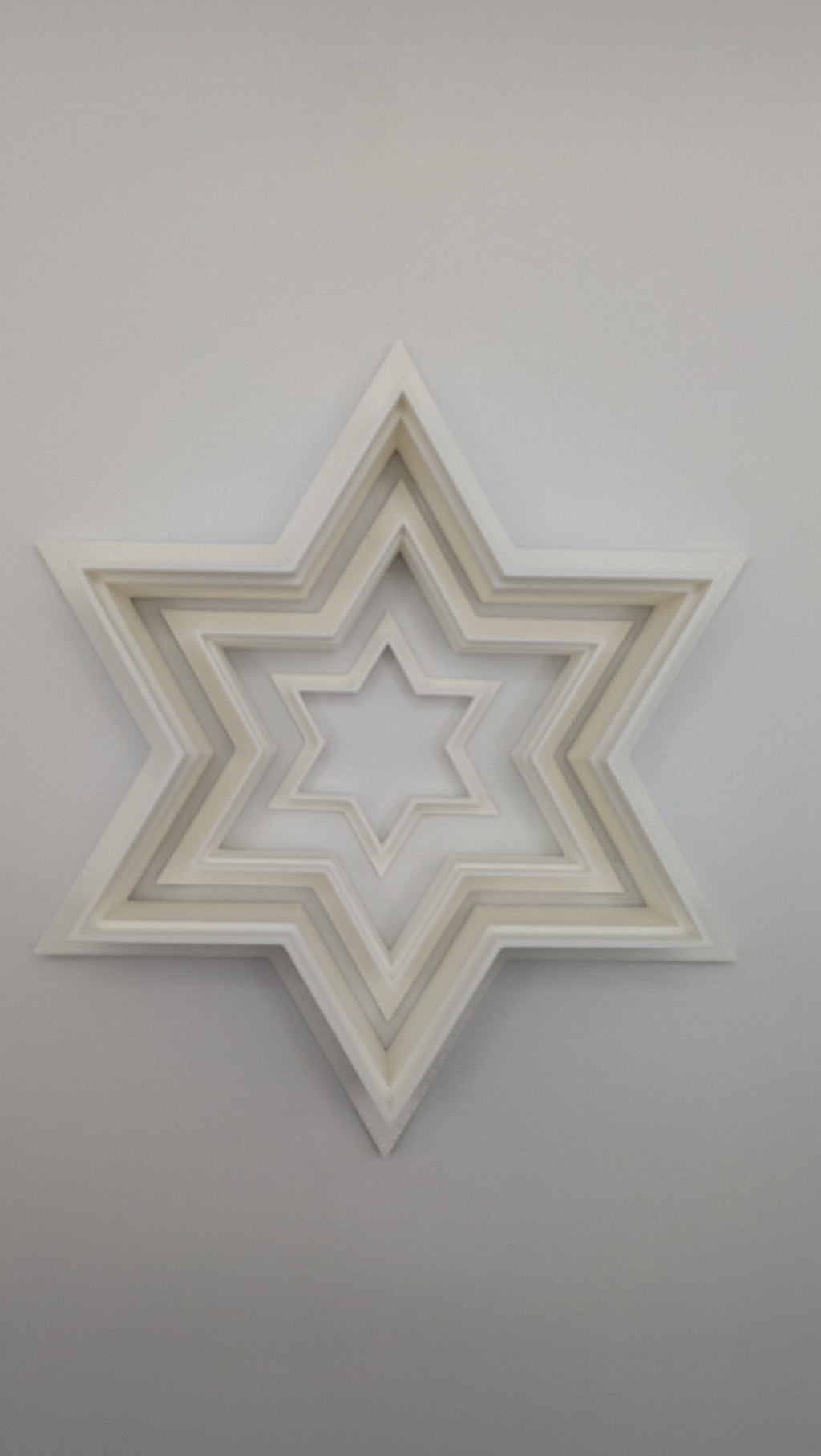 Star of David cookie cutter pressed into sugar cookie dough