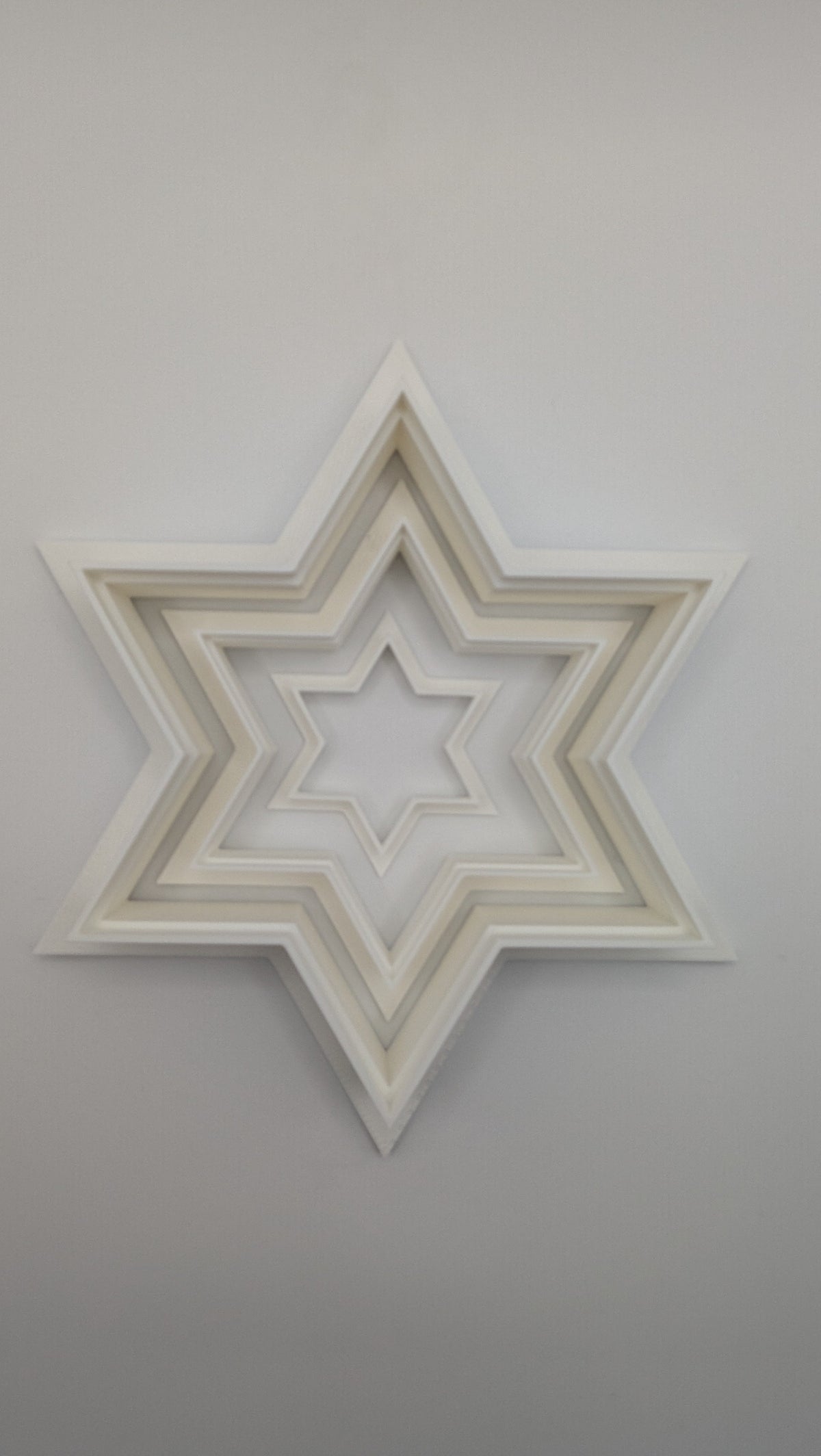 Star of David cookie cutter pressed into sugar cookie dough