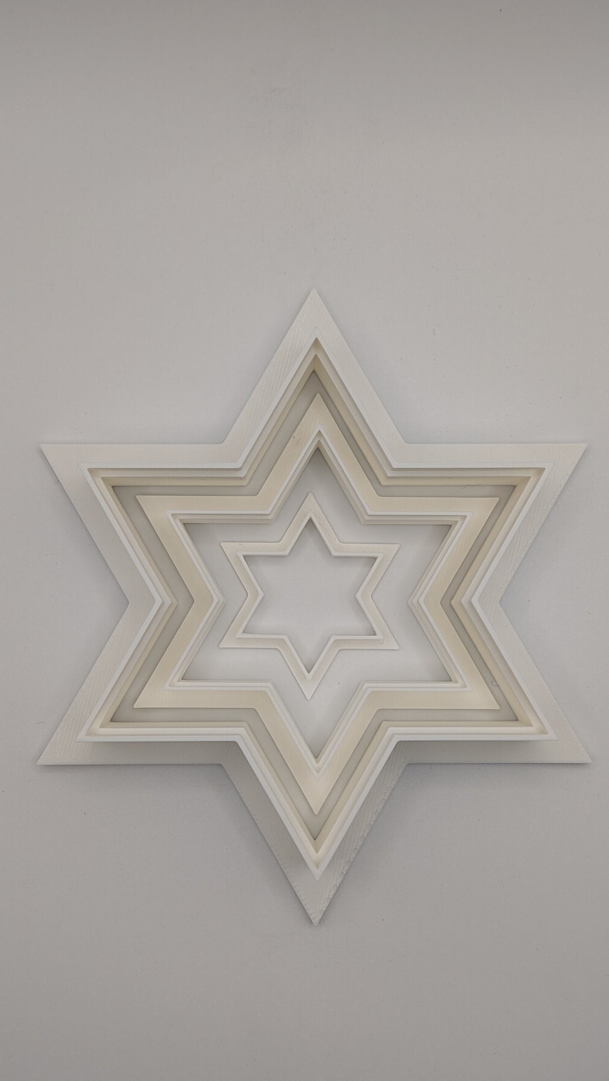 Close-up of a Star of David cookie cutter showing the sharp cutting edge