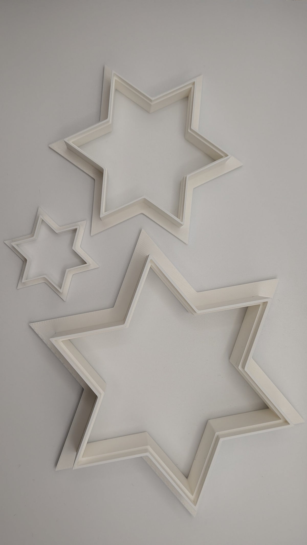 Star of David cookie cutters in 1.5 inch, 3 inch, and 4.5 inch sizes side by side